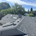 A house with a new gray composition roof and skylights